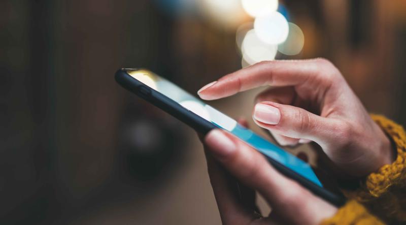 close up image of person tapping phone screen