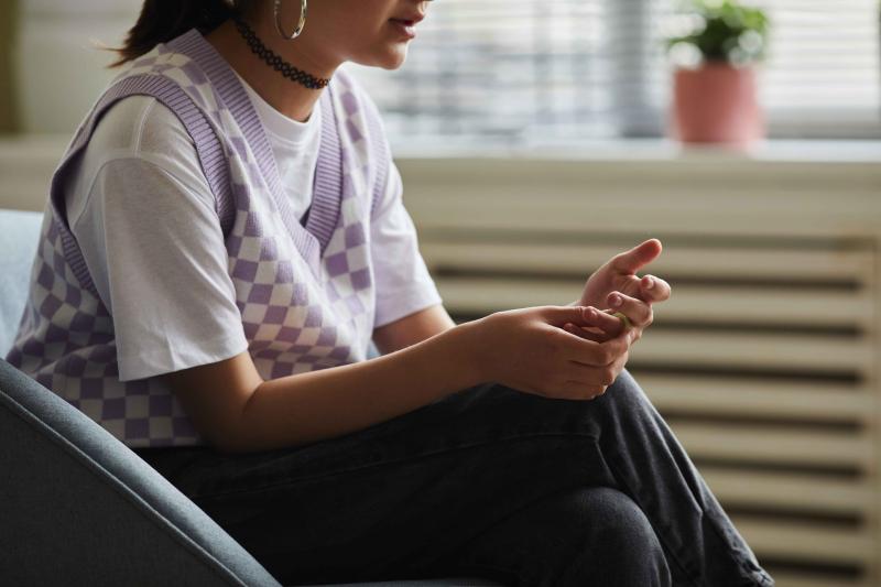a teen sitting and talking in support group
