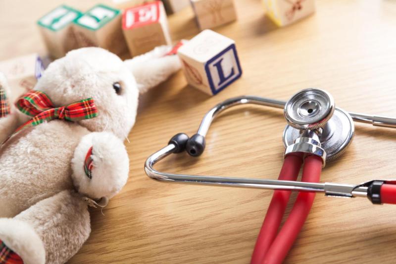 stuffed bunny and stethoscope on floor with letter blocks